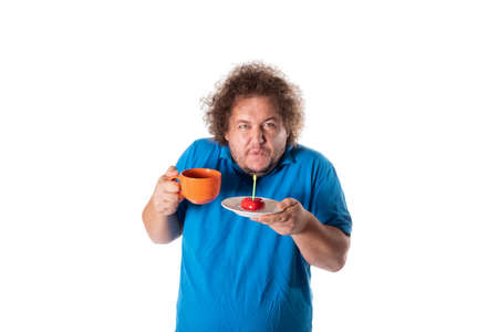 Funny fat man with mug and cake. Happy birthday. Joy and funの写真素材