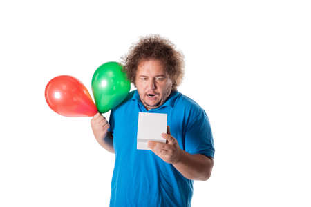 Funny fat man with gift and balloons. Happy birthday. Joy and funの写真素材