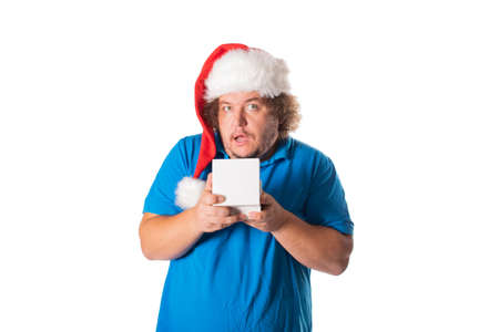 Funny fat man in Santa hat with gifts. Christmas and presents. Emotionsの写真素材