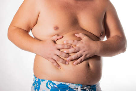 Fat man with big belly. Health problems. Obesity, a sick liverの写真素材