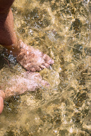 Couple on the sea side. Close up legs image