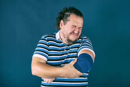 Man holding his sore elbowの写真素材