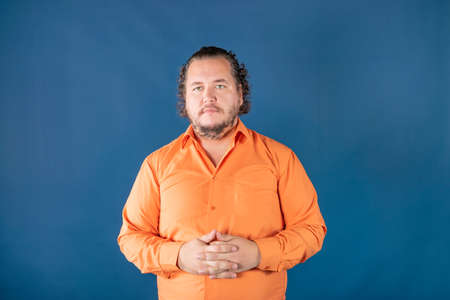 Sad fat man posing in the studio. Health problems. Excess weightの写真素材