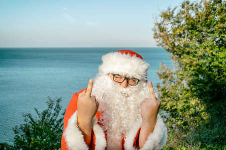 Santa's vacation at sea. Relaxing on the beachの写真素材