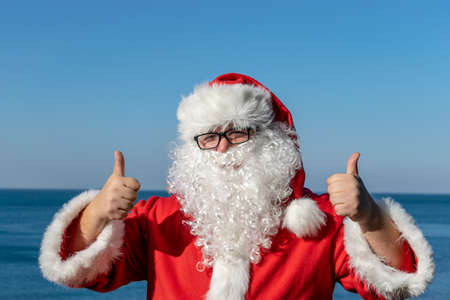 Santa's vacation at sea. Relaxing on the beachの写真素材