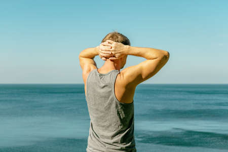 Man enjoying the view and fresh air on the oceanの写真素材