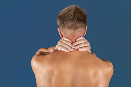 Man holding his neck trying to relieve painの写真素材