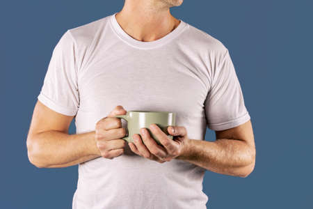Sleepy man with a mug of coffeeの写真素材