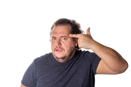 Handsome fat man over isolated white background. Holding symbolic gun with hand gestureの写真素材