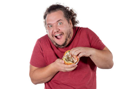 Funny fat man eating hamburger. Fast food, unhealty eatの写真素材