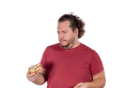 Funny fat man eating hamburger. Fast food, unhealty eatの写真素材