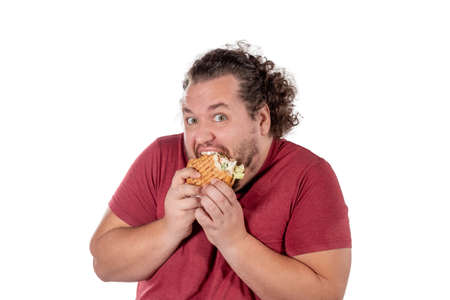 Funny fat man eating hamburger. Fast food, unhealty eatの写真素材
