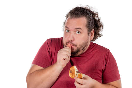 Funny fat man eating croissantの写真素材