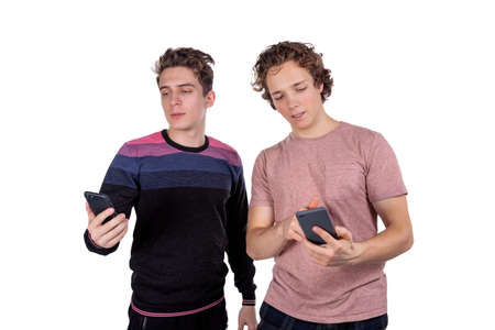 Portrait of a two happy young men using mobile phonesの写真素材