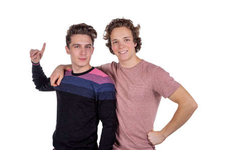 Portrait of a two happy young men pointing fingers isolatedの写真素材