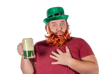 Patricks day party. Portrait of funny fat man holding glass of beerの写真素材