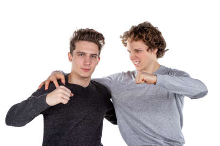 Portrait of two handsome and young furious men fighting with each other on white backgroundの写真素材