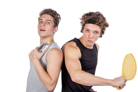 Two handsome guys play tennis isolatedの写真素材