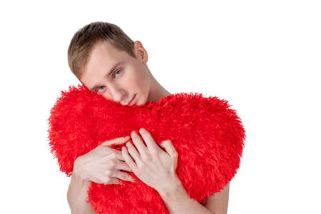 Handsome guy hold big red heart on white background. Love and romantic concept.の写真素材