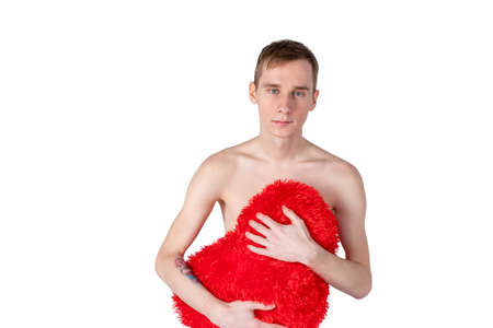 Handsome guy hold big red heart on white background. Love and romantic concept.の写真素材