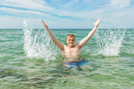 Funny man diver with snorkel equipment snorkeling mask and tube in oceanの写真素材