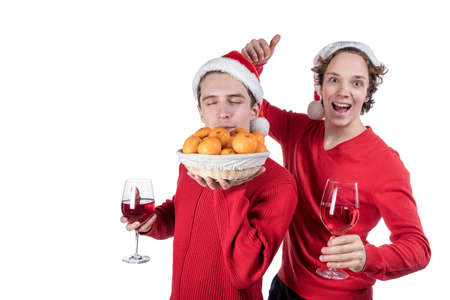Two funny young men celebrating christmas isolatedの写真素材