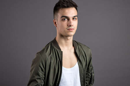 Young serious man posing in studioの写真素材