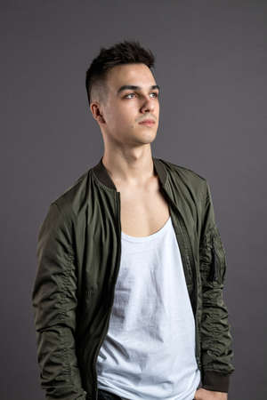 Young serious man posing in studioの写真素材