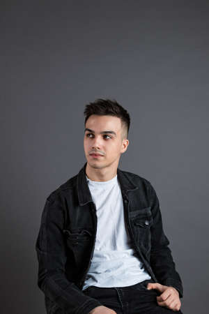 Young serious man posing in studioの写真素材