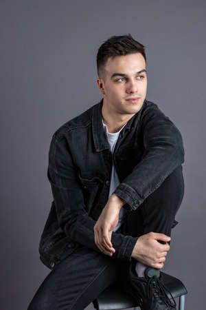 Young serious man posing in studioの写真素材