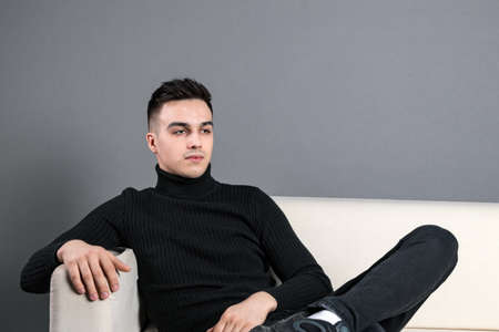 Young serious man posing in studio