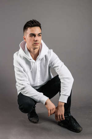 Young serious man posing in studio