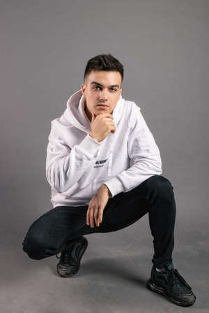 Young serious man posing in studioの写真素材