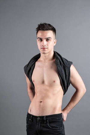 Young serious man posing in studioの写真素材