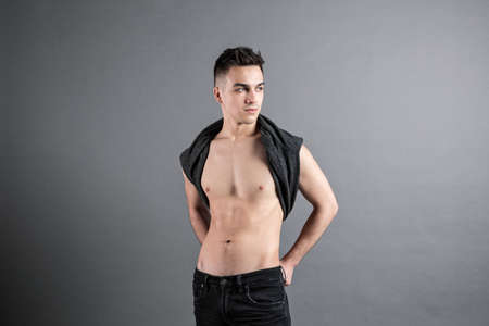 Young serious man posing in studioの写真素材