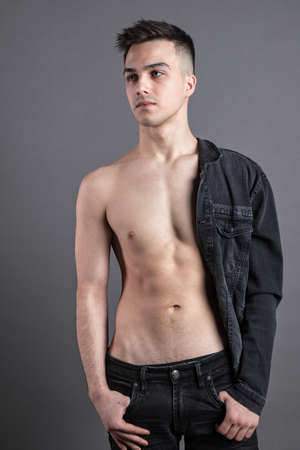 Young serious man posing in studioの写真素材