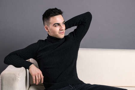 Young serious man posing in studioの写真素材