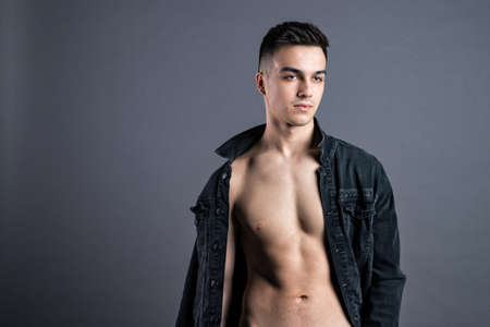 Young serious man posing in studioの写真素材