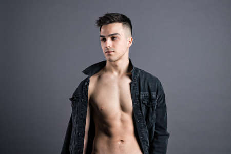 Young serious man posing in studioの写真素材