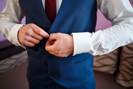 man puts on a suit on the wedding dayの写真素材