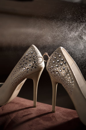 Bride's engagement ring on wedding day with beautiful holiday shoesの写真素材