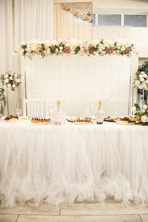 Wedding decor made of flowers and fabric. Beautiful decorations for newlyweds on their wedding dayの写真素材