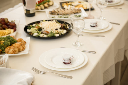 Nicely decorated banquet table with a variety of snacks and sandwich appetizersの写真素材