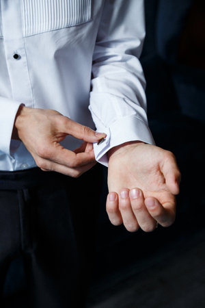 A man puts on a men's suit on the day of the weddingの写真素材