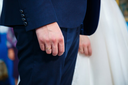 gold wedding rings in the hands of the newlywedsの写真素材