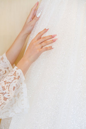 Beautiful young girl bride on a wedding day. White wedding dress. Modern dressy clothes for womenの写真素材