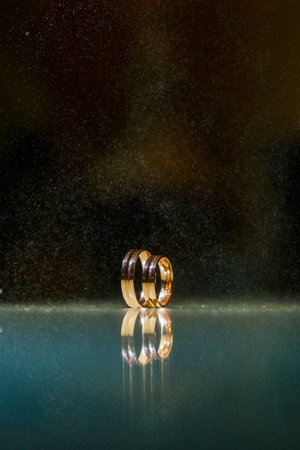 Wedding rings with water droplets,The engagement ring set.,Beautiful silver background with wedding rings and starsの写真素材
