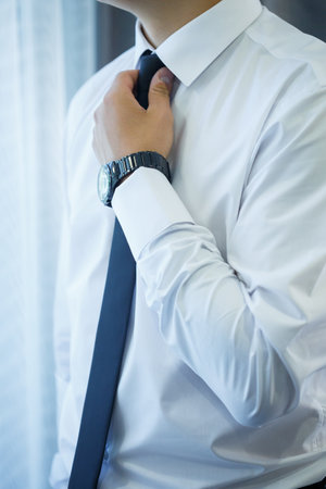 man puts on a suit on the wedding dayの写真素材
