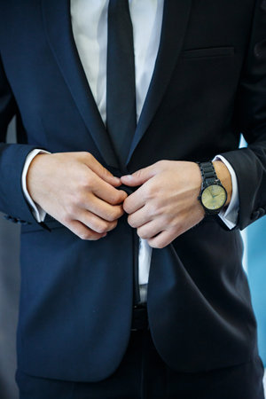 man puts on a suit on the wedding dayの写真素材
