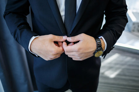 man puts on a suit on the wedding dayの写真素材